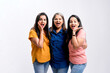 © Niks Ads - Three indian women giving expression together on white background.