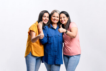 Three indian women giving expression together on white background.