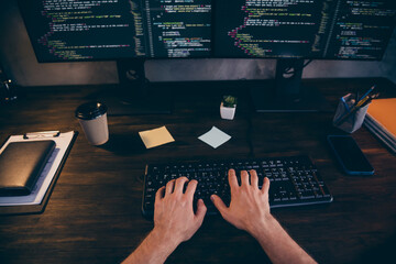 Photo of freelancer hands arms typing software code modern gadget work indoors workplace workstation loft