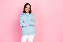Photo Of Pretty Confident Lady Wear Blue Hoodie Smiling Arms Crossed Empty Space Isolated Pink Color Background