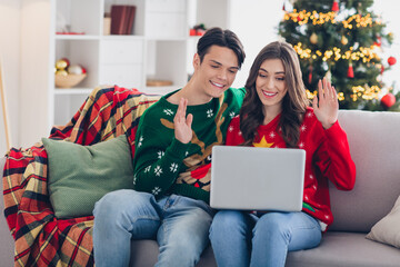 Wall Mural - Photo of attractive tender sweet couple chatting online waving arms hello family close friends xmas morning magic time room indoors house