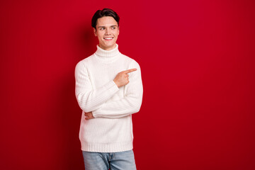 Sticker - Photo of satisfied guy brunet hair wear white sweater look finger direct empty space present low price xmas deal isolated on red color background