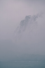 Poster - The cliffs of the Lemaire Channel in Antarctica; are mostly covered in mist or fog. 