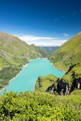 Sticker - Vertical landscape of a lake in the green hills on a sunny day