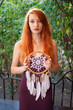 © pliekhova - Portrait of lovely slim redhead girl in wine dress and dreamcatcher craft talisman