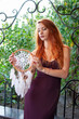 © pliekhova - Portrait of lovely slim redhead girl in wine dress and dreamcatcher craft talisman