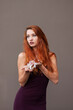 © pliekhova - Portrait of lovely slim redhead girl in wine dress and dreamcatcher craft talisman