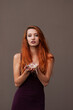 © pliekhova - Portrait of lovely slim redhead girl in wine dress and dreamcatcher craft talisman