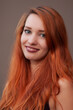 Close-up portrait of beautiful slim girl with long red hair