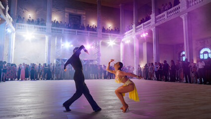 Wall Mural - Couple dancers  perform latin dance on large professional stage. Ballroom dancing.