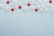 © pundapanda - White and red snowflakes on a blue background, Christmas background, Merry Christmas and Happy New Year concept, top view, copy space