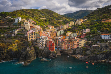 Wall Mural - Riomaggiore, Italy - September 2022: The colorful fishing village of Riomaggiore, Italy, one of the five Cinque Terre Villages along the Ligurian Sea. Aerial drone shot