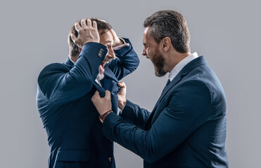 Wall Mural - two arguing businessmen isolated on grey backdrop. businessmen arguing in studio.