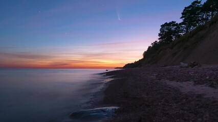 Wall Mural - Comet Neowise in night sky above the beach with a reflection in the water