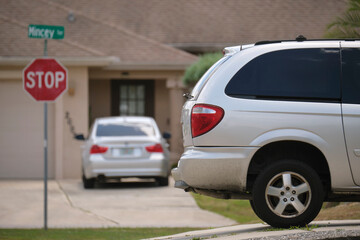 Wall Mural - Car parked in front of wide garage double door on concrete driveway of new modern american house