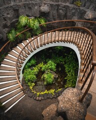 Wall Mural - Top view of curvy Spiral staircase leading into a lava cave at Museo del Campesino, Spain