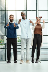 Wall Mural - group of young business people showing the thumbs up .