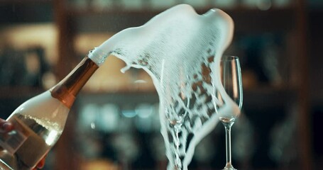 Champagne popping, glasses and a celebration at luxury event or party to celebrate success and achievement. Alcohol, bubbles and explosion of drink to toast or cheers with sparkling wine on counter.