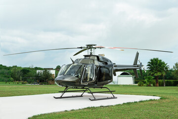 Wall Mural - Beautiful modern helicopter on helipad in field