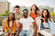 © Jose Calsina - Happy multiracial young people smiling together looking at camera, five teenage friends having fun and laughing taking picture outside on city street. Lifestyle Concept. High quality photo