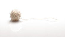 A Ball Of White Woolen Threads On A White Background With A Shadow. Side View.