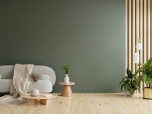 Gray Sofa With Table On Green Wall And Wooden Flooring.