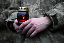 Ukrainian Seviceman Holds A Candle. Candle In Hands Of Soldier