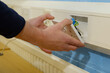 Close-up of electrician installing faceplate on UK double wall socket in office
