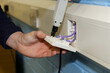 © Chris Mann - Close-up of electrician testing wiring in UK data socket in office
