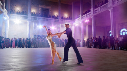 Wall Mural - Couple dancers  perform latin dance on large professional stage. Ballroom dancing.