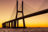 Fototapeta  - Vasco da Gama bridge at sunrise in a cold November morning: this bridge is simply beautiful, curvy and sexy!