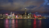 Fototapeta Miasta - Night landscape / skyline of Hong Kong Harbour, showing neon-lit skyscrapers.