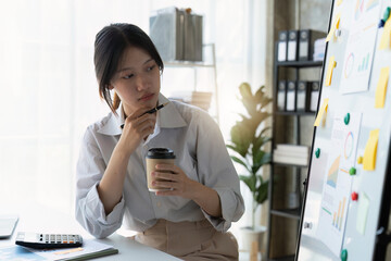 Wall Mural - Asian Business woman working at home office and analyze financial report document. Accounting and Finance concept