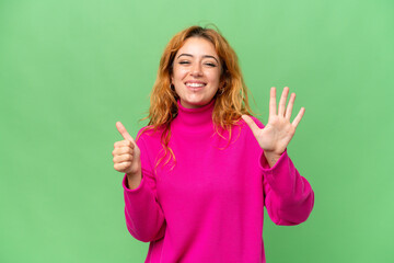 Young caucasian woman isolated on green screen chroma key background counting six with fingers