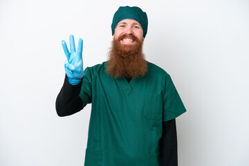 Wall Mural - Surgeon redhead man in green uniform isolated on white background happy and counting three with fingers