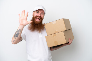 Wall Mural - Delivery reddish man isolated on white background saluting with hand with happy expression