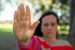 © Pelayo - Unrecognizable woman with raised hand. Concept of stop