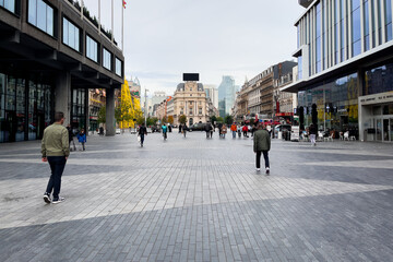 Pedestrians walking in a public square in Brussels