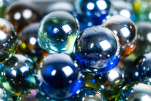 Lots Of Blue And Green Glass Balls, Beads On A White Background, Close-up