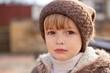 © Тамара Киреева - a large portrait of a sad little boy with big brown eyes in a knitted hat