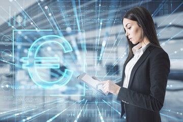Aufkleber - Attractive young european businesswoman pointing at tablet with glowing euro sign hologram on blurry office interior background. Online banking, trade, finance and blockchain concept. Double exposure.