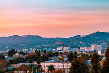 Los Angeles, California Landscape With The Hollywood Sign And Griffith Observatory In The Background During Sunset.