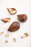 Salak or snake fruit on gray concrete background. Side view, close up, selective focus.