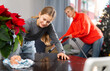 © JackF - Female teenager cleaning table before Christmas dinner, her mother cleaning sofa with vacuum cleaner
