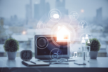 Poster - Desktop computer background in office and big town buildings hologram drawing. Double exposure. Smart city concept.