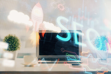 Poster - Double exposure of table with computer and seo drawing hologram. Search optimization concept.