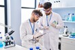 © Krakenimages.com - Young couple wearing scientist uniform working at laboratory