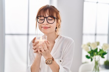 Canvas Print - Young woman smiling confident drinking glass of water at home