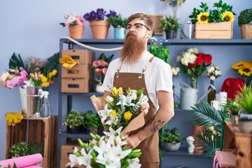 Poster - Young redhead man florist holding bouquet of flowers at flower shop