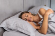 © F8  \ Suport Ukraine - Portrait pretty young girl on bed in modern apartment in the morning.